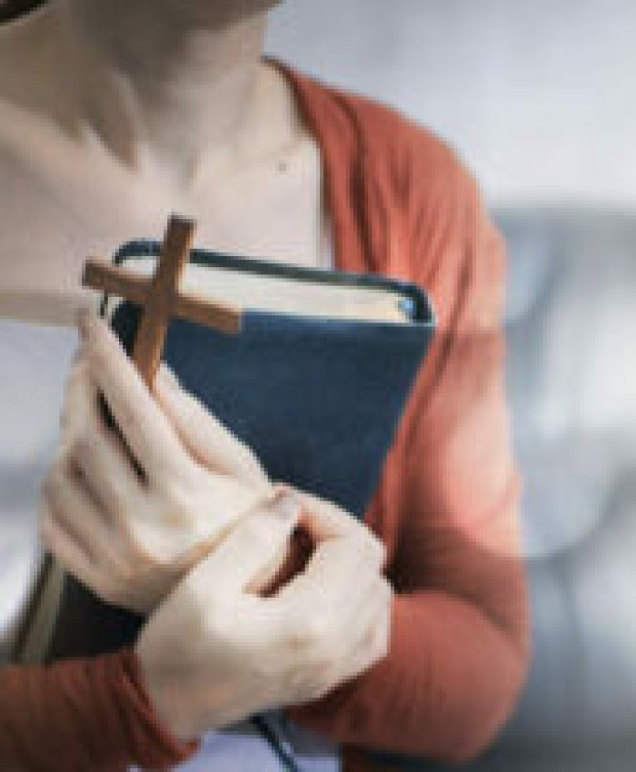 Woman hand with cross.Concept of hope, faith, christianity, religion, church online.