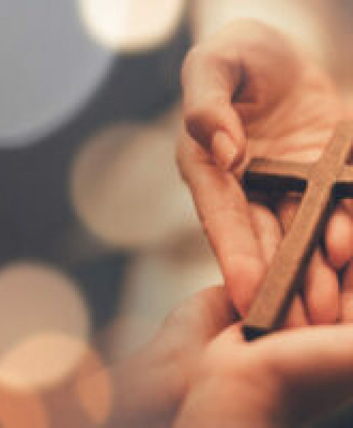 Woman's hand with cross .Concept of hope, faith, christianity, religion, church online.